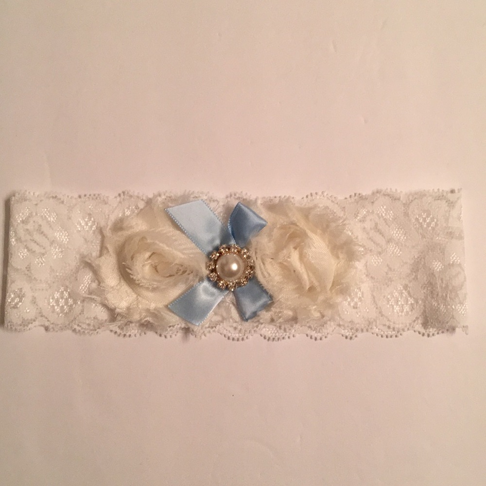 White and ivory lace garter with blue ribbon